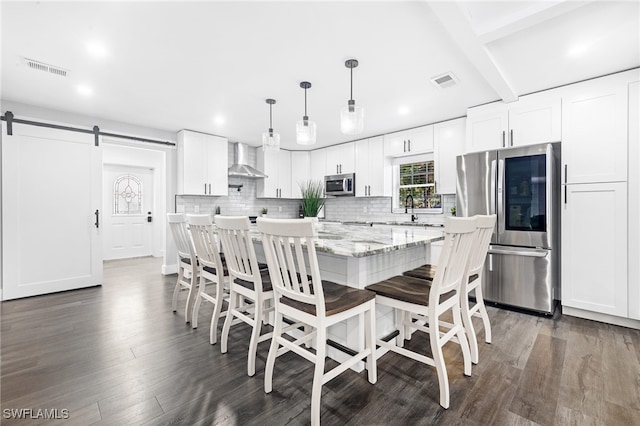 1330 Rock Rd, Naples, FL 34120 - dining room with dark wood-type flooring, recessed lighting, a barn door, and visible vents