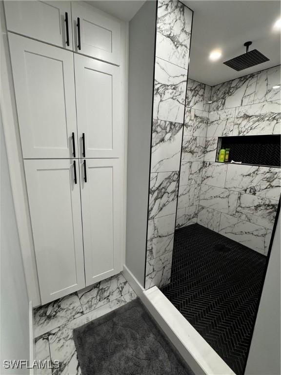 1330 Rock Rd, Naples, FL 34120 - bathroom with baseboards, marble finish floor, and a marble finish shower