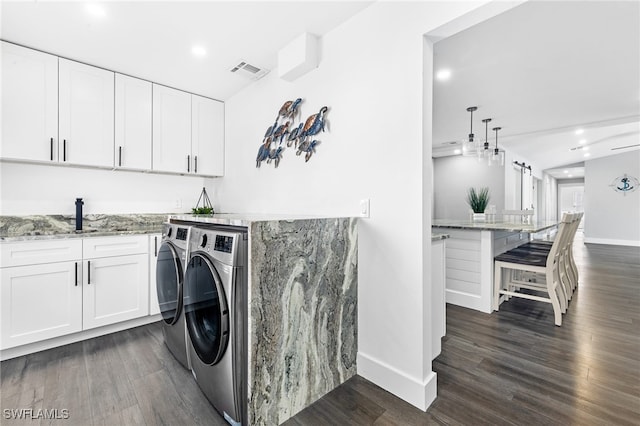 1330 Rock Rd, Naples, FL 34120 - laundry area with washing machine and clothes dryer, a sink, dark wood finished floors, baseboards, and visible vents