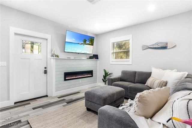 1330 Rock Rd, Naples, FL 34120 - living room with a glass covered fireplace, baseboards, recessed lighting, and wood finished floors