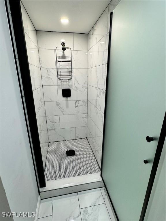 1330 Rock Rd, Naples, FL 34120 - bathroom featuring a stall shower and marble finish floor