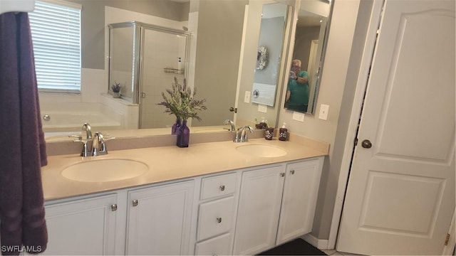 full bath with a stall shower, double vanity, and a garden tub