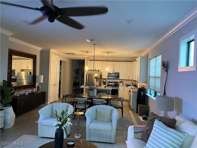 17337 Terracina Dr, Fort Myers, FL 33913 - living area featuring crown molding, ceiling fan, light wood finished floors, and visible vents