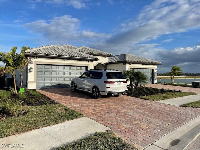 17337 Terracina Dr, Fort Myers, FL 33913 - view of front of home with a tile roof, a garage, and decorative driveway