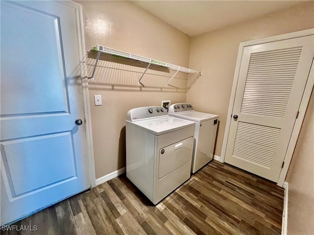 washroom with washer and dryer, dark wood finished floors, and baseboards