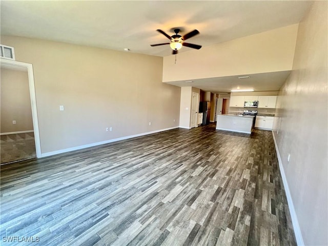 unfurnished living room featuring baseboards, dark wood-style floors, and a ceiling fan