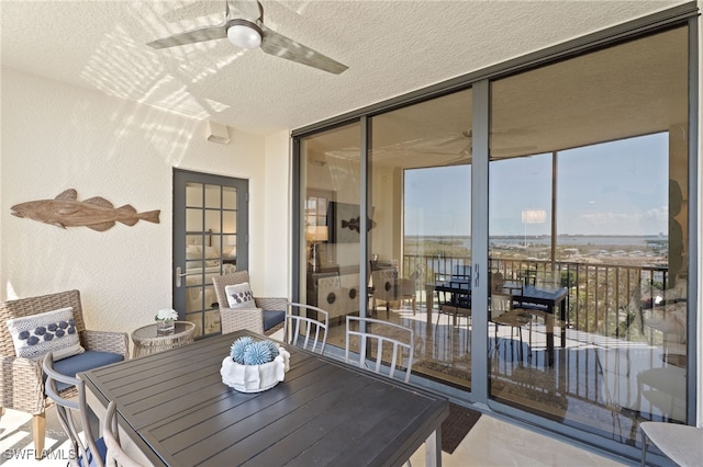 5793 Cape Harbour Dr Unit 1111, Cape Coral, FL 33914 - exterior space with a textured wall, a wall of windows, a ceiling fan, and a textured ceiling