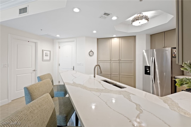5793 Cape Harbour Dr Unit 1111, Cape Coral, FL 33914 - kitchen featuring stainless steel fridge with ice dispenser, a kitchen breakfast bar, visible vents, and a sink