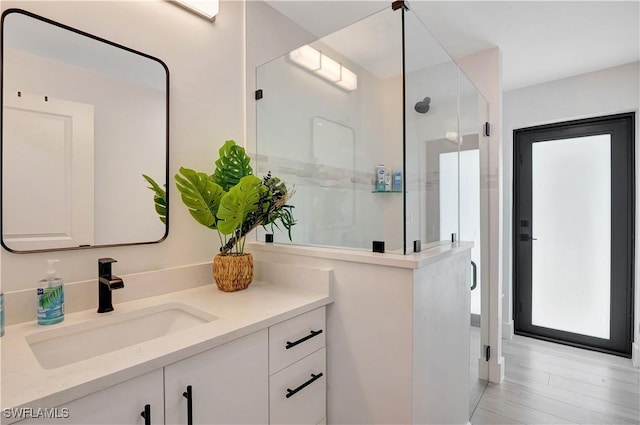 bathroom with a stall shower and vanity