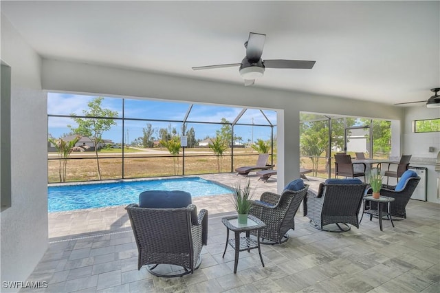 swimming pool featuring ceiling fan, a patio area, and a lanai