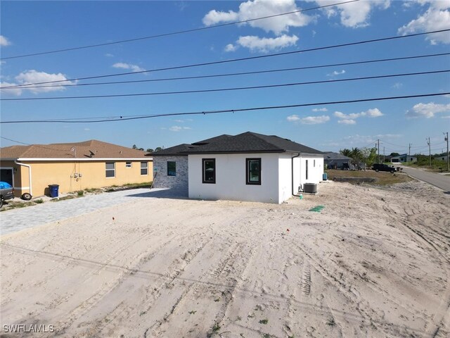 2619 15th St SW, Lehigh Acres, FL 33976 - back of house with stucco siding