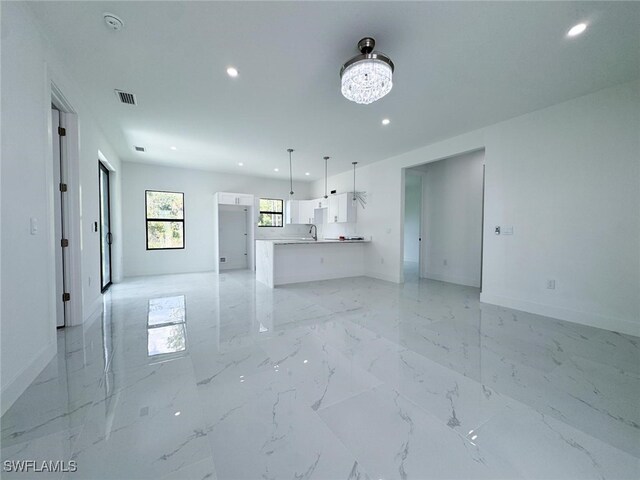 2619 15th St SW, Lehigh Acres, FL 33976 - unfurnished living room with recessed lighting, baseboards, and visible vents