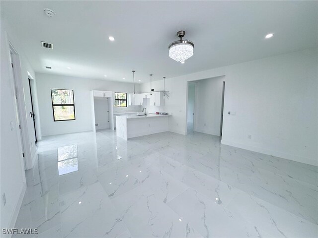 2619 15th St SW, Lehigh Acres, FL 33976 - unfurnished living room with visible vents, recessed lighting, and baseboards