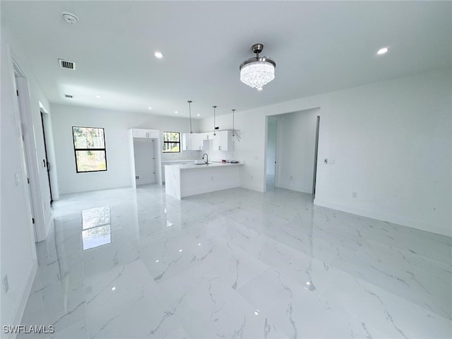 2619 15th St SW, Lehigh Acres, FL 33976 - unfurnished living room featuring recessed lighting and light marble finish floors