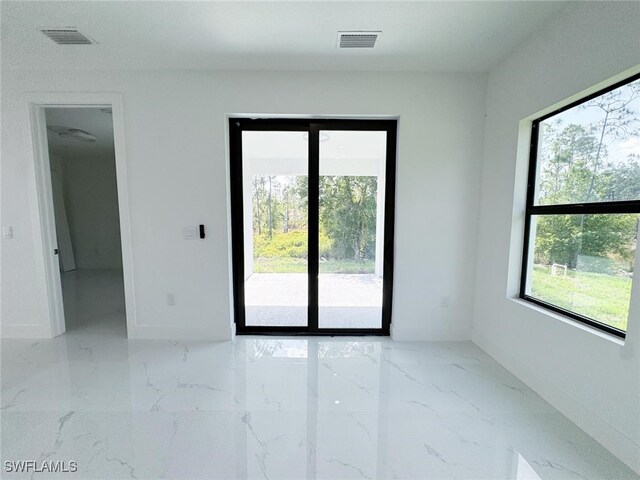 2619 15th St SW, Lehigh Acres, FL 33976 - empty room featuring baseboards, visible vents, and marble finish floor