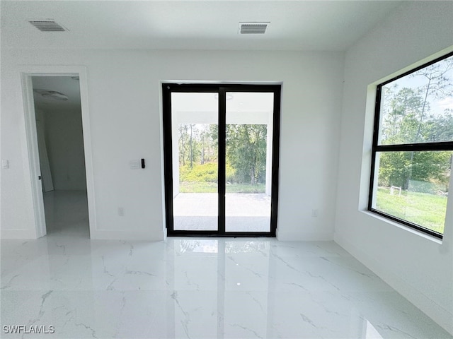 2619 15th St SW, Lehigh Acres, FL 33976 - spare room with marble tiled flooring and baseboards