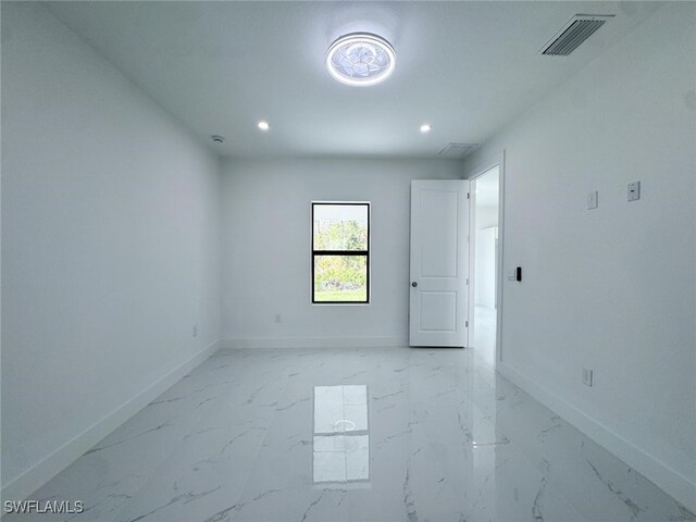 2619 15th St SW, Lehigh Acres, FL 33976 - empty room featuring baseboards, marble finish floor, recessed lighting, and visible vents