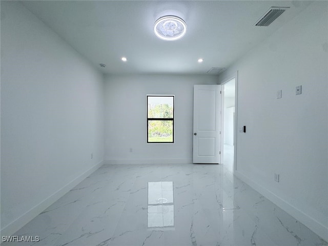 2619 15th St SW, Lehigh Acres, FL 33976 - empty room featuring recessed lighting and light marble finish flooring