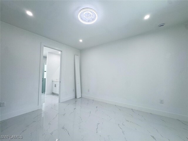 2619 15th St SW, Lehigh Acres, FL 33976 - empty room with baseboards, recessed lighting, and marble finish floor