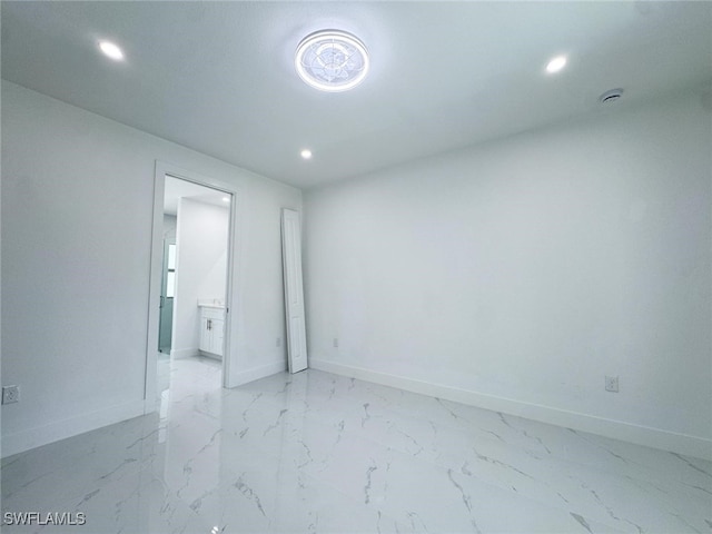 2619 15th St SW, Lehigh Acres, FL 33976 - unfurnished room featuring recessed lighting, light marble finish flooring, and a smoke detector