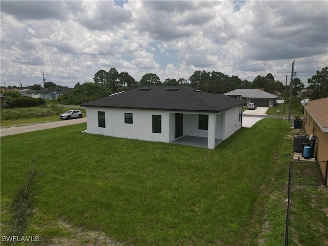 2619 15th St SW, Lehigh Acres, FL 33976 - back of property with a patio, stucco siding, and a shingled roof