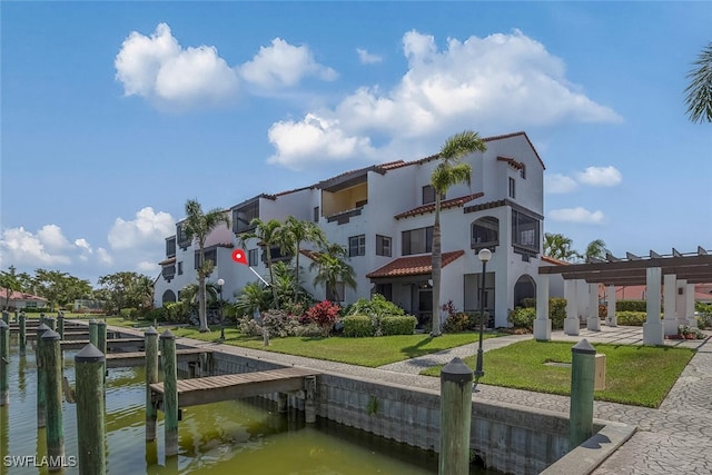 15110 Ports Of Iona Dr Unit 102, Fort Myers, FL 33908 - exterior space with a boat dock, a water view, and a yard