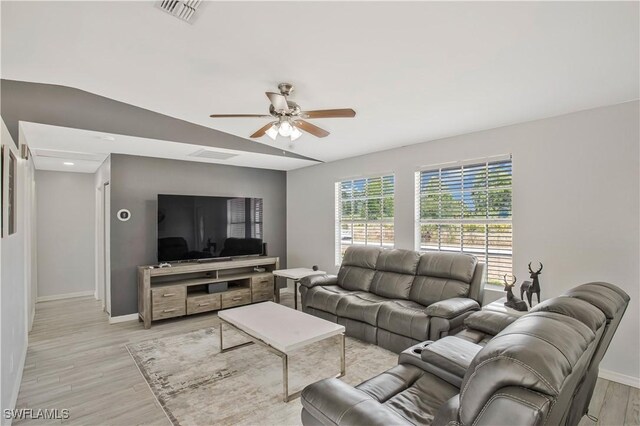 living room with ceiling fan, baseboards, light wood-style floors, and recessed lighting