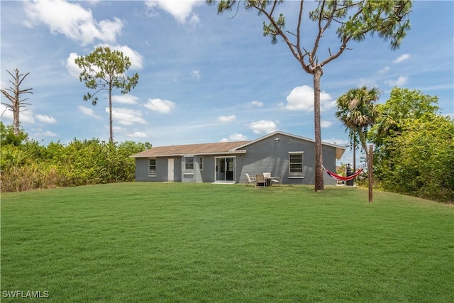 back of house with a yard