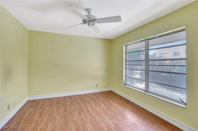 722 Broad Ave S Unit 722, Naples, FL 34102 - unfurnished room with light wood-style flooring, healthy amount of natural light, baseboards, and ceiling fan