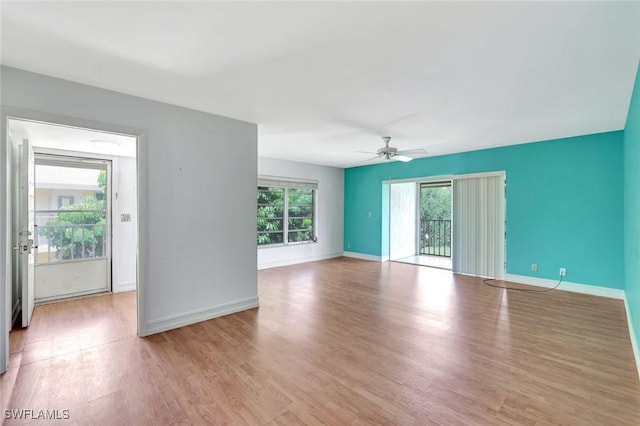 722 Broad Ave S Unit 722, Naples, FL 34102 - unfurnished living room with healthy amount of natural light, wood finished floors, and baseboards