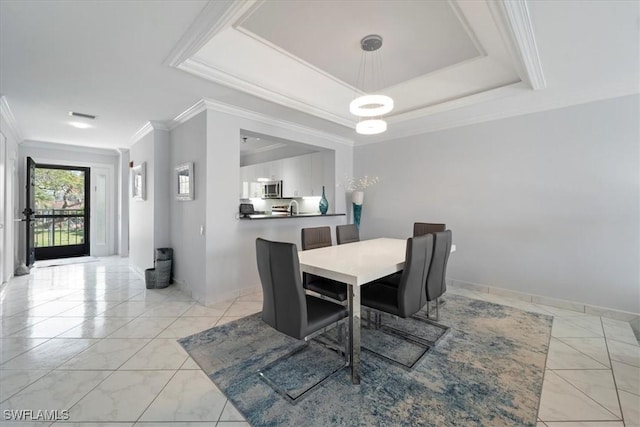 dining room featuring crown molding, a raised ceiling, baseboards, and marble finish floor