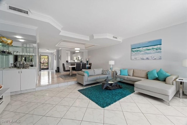 living area featuring crown molding, visible vents, and a raised ceiling