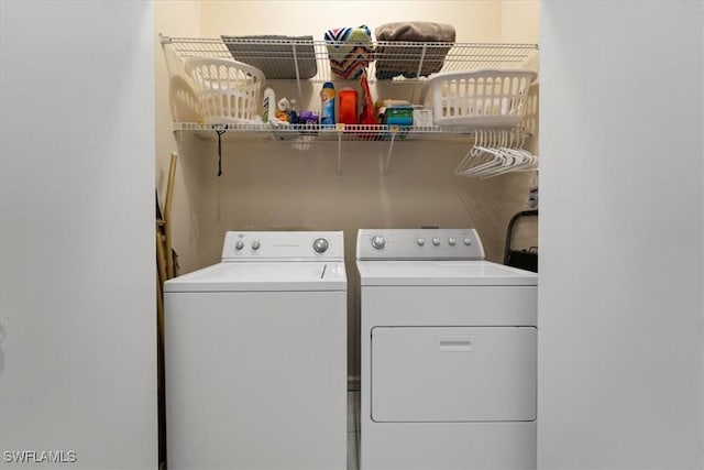 clothes washing area with laundry area and washer and clothes dryer