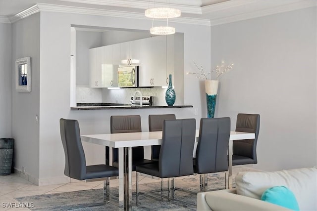 dining area with crown molding and baseboards