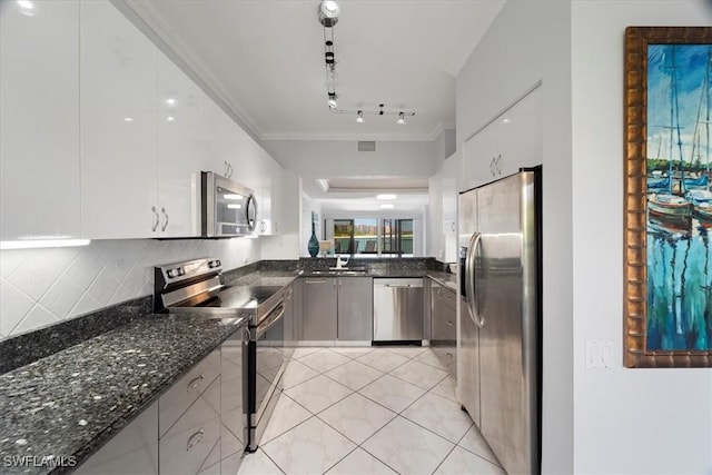 kitchen featuring dark stone countertops, stainless steel appliances, backsplash, visible vents, and ornamental molding