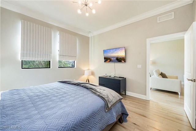15102 Palmer Lake Cir Unit 201, Naples, FL 34109 - bedroom with wood finished floors, ornamental molding, a chandelier, and baseboards