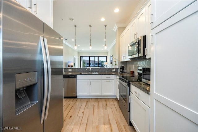 15102 Palmer Lake Cir Unit 201, Naples, FL 34109 - kitchen with appliances with stainless steel finishes, a sink, crown molding, white cabinets, and light wood-style floors