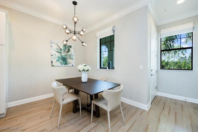15102 Palmer Lake Cir Unit 201, Naples, FL 34109 - dining area featuring a chandelier, crown molding, light wood-style floors, and baseboards