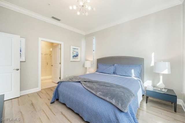 15102 Palmer Lake Cir Unit 201, Naples, FL 34109 - bedroom with wood finished floors, crown molding, a chandelier, baseboards, and connected bathroom