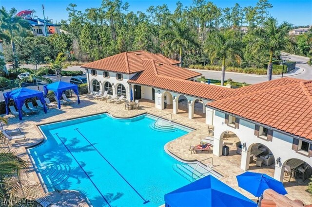 15102 Palmer Lake Cir Unit 201, Naples, FL 34109 - community pool with a gazebo and a patio area