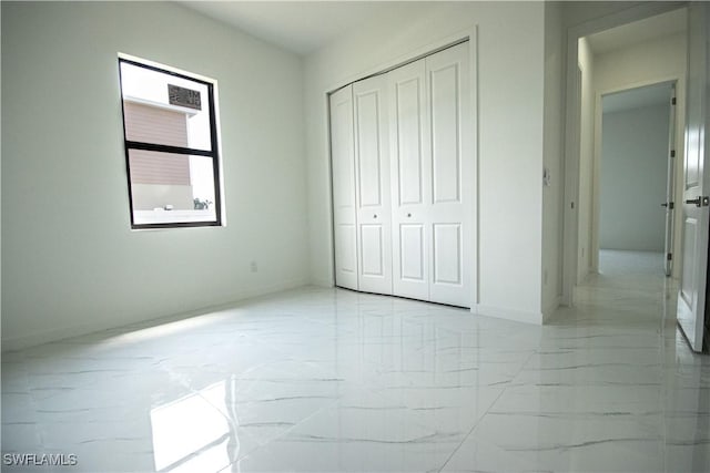 2808 NW 21st Ave, Cape Coral, FL 33993 - unfurnished bedroom with baseboards, a closet, and marble finish floor