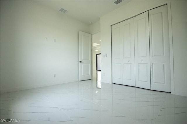 2808 NW 21st Ave, Cape Coral, FL 33993 - unfurnished bedroom featuring visible vents, marble finish floor, baseboards, and a closet