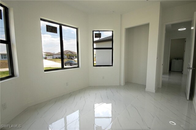 2808 NW 21st Ave, Cape Coral, FL 33993 - unfurnished room with washer / dryer, baseboards, and marble finish floor