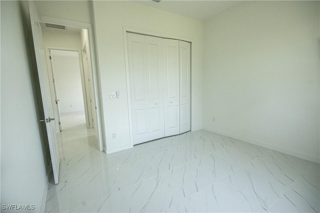 2808 NW 21st Ave, Cape Coral, FL 33993 - unfurnished bedroom with baseboards, a closet, marble finish floor, and visible vents