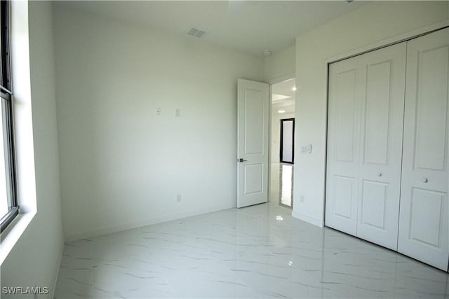 2808 NW 21st Ave, Cape Coral, FL 33993 - unfurnished bedroom with baseboards, visible vents, marble finish floor, and a closet