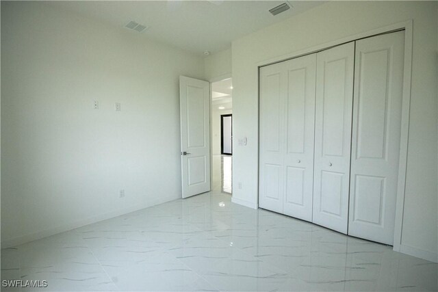 2808 NW 21st Ave, Cape Coral, FL 33993 - unfurnished bedroom featuring baseboards, visible vents, marble finish floor, and a closet