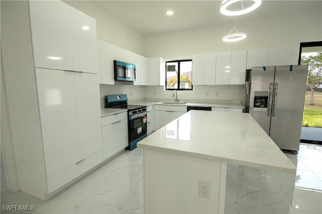 2808 NW 21st Ave, Cape Coral, FL 33993 - kitchen with marble finish floor, modern cabinets, white cabinets, a sink, and appliances with stainless steel finishes