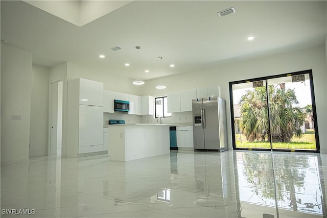 2808 NW 21st Ave, Cape Coral, FL 33993 - kitchen with stainless steel fridge, white cabinets, black microwave, and visible vents