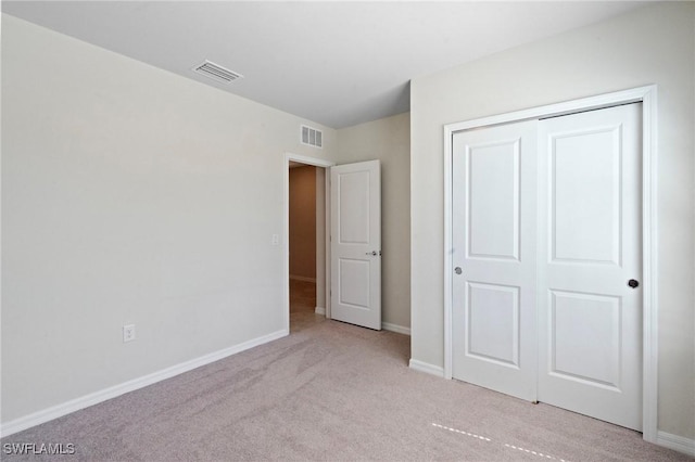 16044 Enclaves Cove Dr, North Fort Myers, FL 33917 - unfurnished bedroom with visible vents, baseboards, a closet, and light colored carpet