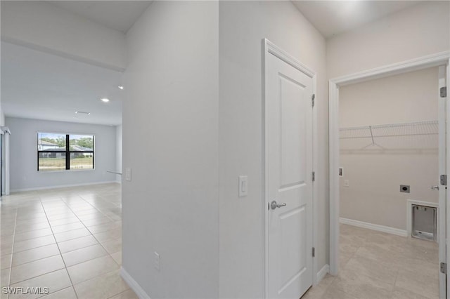 16044 Enclaves Cove Dr, North Fort Myers, FL 33917 - corridor featuring light tile patterned floors and baseboards